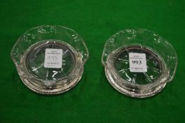 A pair of cut glass and silver mounted dishes.
