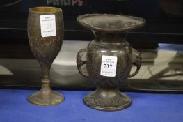 An Indian engraved brass vase and a similar goblet.