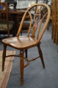 A set of ten beech and elm splat back windsor dining chairs, the backs carved with a liver bird.