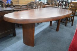 A large heavy and unusual shape top dining table on column supports, overall size 7'9