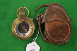 A leather cased military compass.