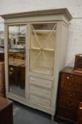 A good grey painted French armoire with a single mirrored door, glazed door and three small
