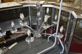 A stylish chrome plated and cut glass nine branch chandelier.