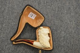 A cased meerschaum pipe depicting Bacchus god of wine.
