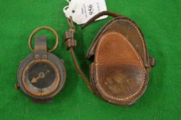 A leather cased military compass.