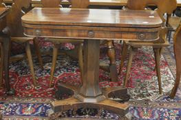 An early 19th century rosewood D shaped fold-over card table on column support with concave sided