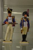 A pair of porcelain model soldiers.