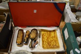 Faux tortoiseshell dressing table items.