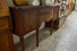 A mahogany serpentine fronted sideboard.