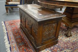 A modern carved oak coffer.