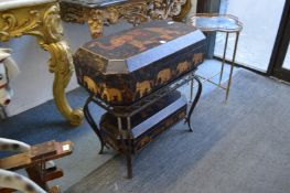 A decorative Indian storage unit with two boxes on a wrought iron stand, both decorated with