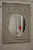 A decorative grey painted wall mirror.