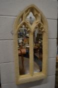 A good gothic style arch shaped mirror modelled as a stone window.