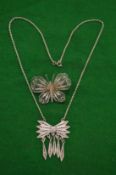 A filigree silver butterfly brooch and a pendant and chain.