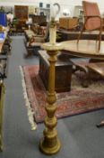 A carved giltwood floor standing lamp.