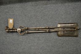A pair of steel fire irons.