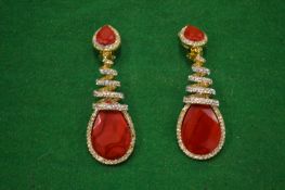 A pair of decorative drop ear clips.