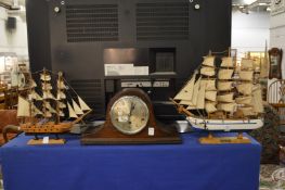 Two model ships and a mantel clock.