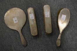 A silver backed four piece dressing table set.