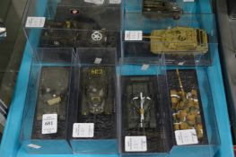 Six various die cast tanks and trucks, in a perspex case.