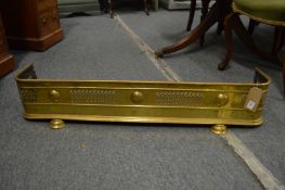 A 19th century brass pierced fender on two bun feet, 3' 5