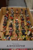 A large collection of miniature military figures on wooden bases.