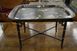 A good chinoiserie style gilded and painted tray table with faux bamboo base.