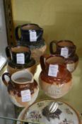 A group of five Royal Doulton salt glazed jugs.