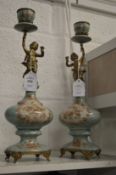 A pair of decorative figural candlesticks.
