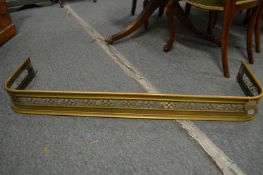 A 19th century brass pierced fender on two bun feet, 3' 9