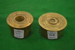 A set of brass cup weights and a part set of cup weights.