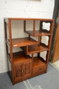 A Chinese hardwood display unit with small cupboard and drawer.