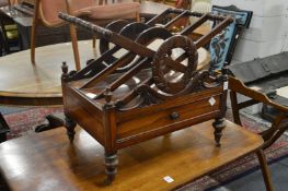 An early 19th century rosewood three division canterbury with a single drawer on turned feet with