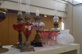 Decorative oil lamps, one converted to electricity.