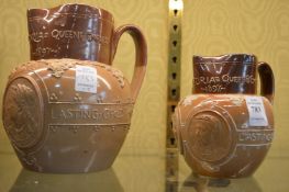 Two Royal Doulton salt glazed jugs commemorating Queen Victoria.