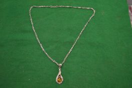 A silver pendant and chain.
