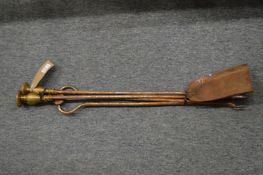 A pair of brass and steel fire irons.