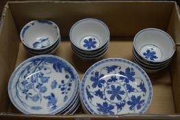 A collection of Chinese blue and white tea bowls and saucers.