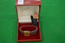 An Omega wrist watch and another watch.