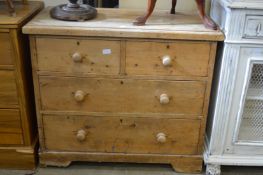 A small pine chest of drawers.