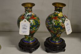 A small pair of cloisonne vases and stands.