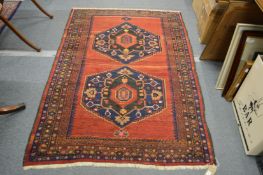 A good small Persian carpet red ground with two large central medallions 7' 2