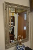 A large decorative gilt framed mirror.