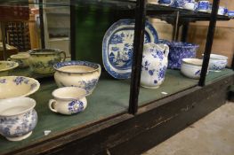 A quantity of blue and white china to include a foot bath, chamber pot, large jug, meat plate etc.
