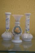An opaque glass vase and a pair of similar vases.