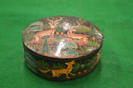 A papier mache box decorated with deer.