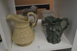 Various decorative jugs and a tankard.