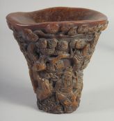 A GOOD CHINESE CARVED HORN LIBATION CUP carved with figures. 5.5ins long.