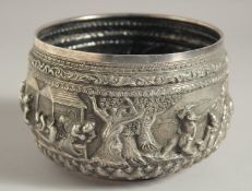 AN INDIAN SILVER CIRCULAR BOWL embossed with figures and animals etc.. 5 ins diameter.