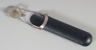 A GEORGE V SILVER BOUND LEATHER SPECTACLE CASE AND CHAIN. Birmingham, 1920.